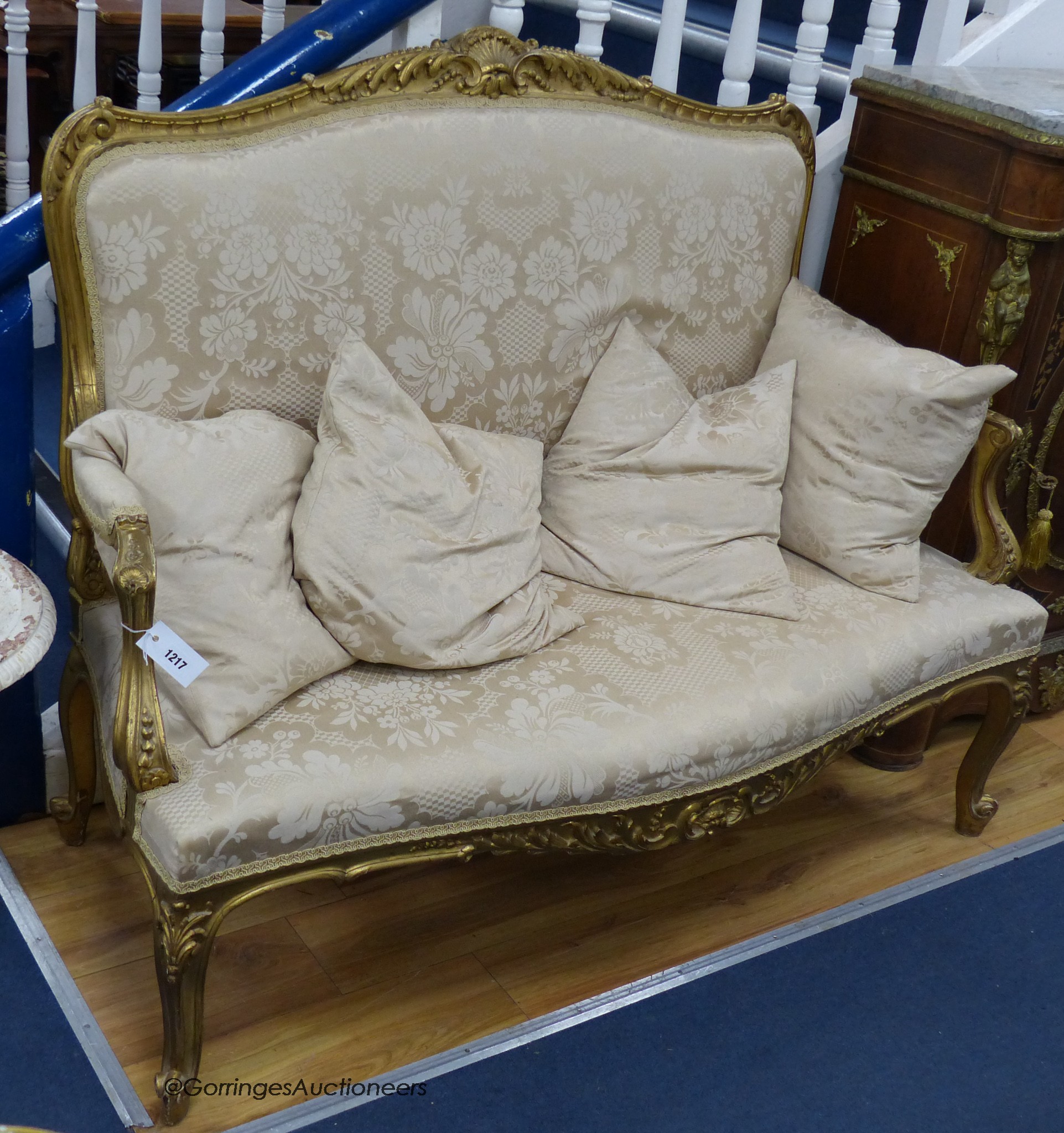 An early 20th century Louis XV style giltwood and gesso canapé, width 134cm, depth 56cm, height 106cm